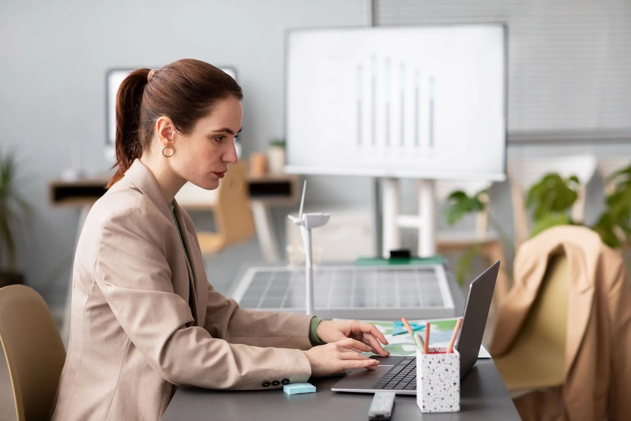 Employee using workplace technology and a laptop, illustrating how shadow AI tools are adopted for business tasks